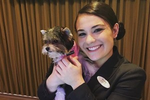 Hotel staffer with a cutesy pet dog